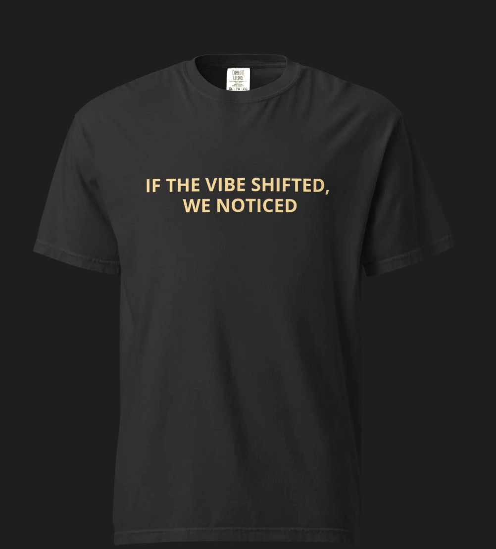 Black tee with gold If the Vibe Shifted, We Noticed lettering