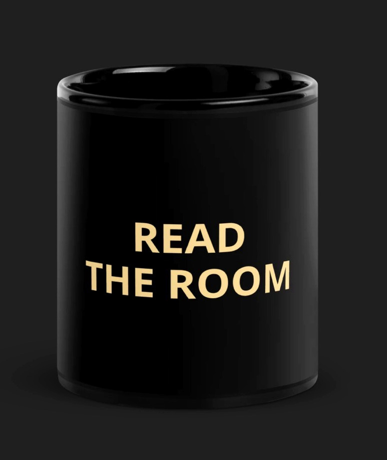 Read the Room black mug with gold lettering